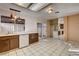 Bright kitchen with tile floor, dark cabinets, and access to the backyard at 335 Greenbriar Townhouse Way, Las Vegas, NV 89121