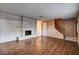 Bright living room featuring hardwood floors, a fireplace, a staircase, and neutral paint at 335 Greenbriar Townhouse Way, Las Vegas, NV 89121