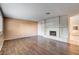 Spacious living room with hardwood floors and a white brick fireplace for cozy evenings at 335 Greenbriar Townhouse Way, Las Vegas, NV 89121