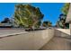 A private patio offers views of mature trees and community features at 335 Greenbriar Townhouse Way, Las Vegas, NV 89121