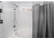 Bright bathroom featuring a tiled shower and tub with a gray shower curtain at 3617 Walnut Wood St, Las Vegas, NV 89129