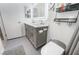 Bathroom featuring dual sinks with modern vanity, shelving, toilet and gray tiled floors at 3617 Walnut Wood St, Las Vegas, NV 89129