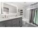 Modern bathroom featuring double vanity, granite countertop, and bathtub shower at 3617 Walnut Wood St, Las Vegas, NV 89129