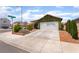 Inviting single-story home features a spacious driveway and charming landscaping at 3617 Walnut Wood St, Las Vegas, NV 89129