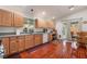 Bright kitchen featuring wood cabinetry, granite countertops, stainless sink, and beautiful wood look tile flooring at 3617 Walnut Wood St, Las Vegas, NV 89129