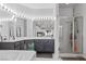 Bathroom with dual sinks, shower with glass doors, large mirror and modern fixtures at 3632 Julia Waldene Ct, Las Vegas, NV 89129