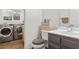 Modern bathroom featuring a sleek vanity, toilet and a separate laundry area at 3632 Julia Waldene Ct, Las Vegas, NV 89129