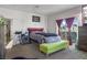 Bright bedroom with carpet, a sliding glass door to a balcony, and a gray and burgundy color scheme at 3632 Julia Waldene Ct, Las Vegas, NV 89129