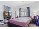 Bedroom features carpet, bedside table, lamp, window, and an office workspace with desk and television at 3632 Julia Waldene Ct, Las Vegas, NV 89129