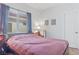 Simple bedroom featuring a bed, window with blinds, bedside table with lamp, and a door at 3632 Julia Waldene Ct, Las Vegas, NV 89129