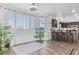 Bright living room featuring a large window, indoor plants and wood flooring at 3632 Julia Waldene Ct, Las Vegas, NV 89129