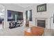 Living room with fireplace, large TV, and wood floors at 3632 Julia Waldene Ct, Las Vegas, NV 89129
