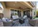 Relaxing covered patio features stylish furniture and a fire pit table at 3698 Regatta Landing Dr, Las Vegas, NV 89141
