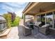 Covered patio featuring ample seating, a fireplace, and a view of the manicured backyard at 3698 Regatta Landing Dr, Las Vegas, NV 89141