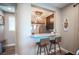Cozy bar area featuring granite countertops, storage shelving, and seating for two bar stools at 3698 Regatta Landing Dr, Las Vegas, NV 89141