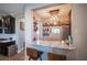 Bar area with granite countertops, custom shelving and bar stool seating at 3698 Regatta Landing Dr, Las Vegas, NV 89141