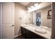 Upstairs bathroom featuring double sinks, stylish fixtures, large mirror, and modern lighting at 3698 Regatta Landing Dr, Las Vegas, NV 89141