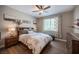 Comfortable bedroom features a ceiling fan, wood-look flooring and matching wood furniture at 3698 Regatta Landing Dr, Las Vegas, NV 89141