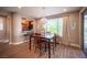 Dining room featuring a wooden table with seating for six and natural light from the window at 3698 Regatta Landing Dr, Las Vegas, NV 89141