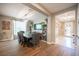 Dining room with a large wooden table and chairs, modern chandelier, and neutral color palette at 3698 Regatta Landing Dr, Las Vegas, NV 89141