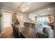 Spacious dining room with a large table, staircase, and view of the living area at 3698 Regatta Landing Dr, Las Vegas, NV 89141