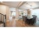 Open-concept dining room showcases a rustic table, stylish chairs, and hardwood floors at 3698 Regatta Landing Dr, Las Vegas, NV 89141