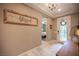 Inviting entryway featuring a 'blessed' sign, chandelier, and view into the bedroom at 3698 Regatta Landing Dr, Las Vegas, NV 89141