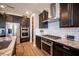 Modern kitchen with stainless steel appliances, gas range, subway tile backsplash, and dark cabinets at 3698 Regatta Landing Dr, Las Vegas, NV 89141