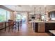 Open concept kitchen with stainless steel appliances, granite countertops, and an island with bar stools at 3698 Regatta Landing Dr, Las Vegas, NV 89141