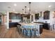 Kitchen with a large granite-topped kitchen island, stainless steel appliances, and dark cabinetry at 3698 Regatta Landing Dr, Las Vegas, NV 89141