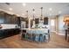 Open concept kitchen with a large kitchen island, stainless steel appliances, and dark cabinetry at 3698 Regatta Landing Dr, Las Vegas, NV 89141