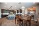 Spacious kitchen with granite countertops, stainless steel appliances, and breakfast bar overlooking dining area at 3698 Regatta Landing Dr, Las Vegas, NV 89141