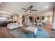 Bright living room with two sofas, a ceiling fan, and an open floor plan into the kitchen and dining area at 3698 Regatta Landing Dr, Las Vegas, NV 89141