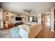 Stylish living room boasts a ceiling fan, shelves, and seamless access to the dining area at 3698 Regatta Landing Dr, Las Vegas, NV 89141