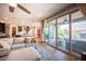 Living room flowing to outdoor patio with ceiling fan and floor to ceiling glass doors at 3698 Regatta Landing Dr, Las Vegas, NV 89141