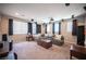 Inviting Gathering room featuring home theatre, large windows, and plush furnishings at 3698 Regatta Landing Dr, Las Vegas, NV 89141