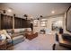 Open-concept Gathering room with comfortable seating, a projector screen, and decorative shelving units at 3698 Regatta Landing Dr, Las Vegas, NV 89141