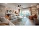 Bright living room flows to kitchen and features a ceiling fan and sliding door to outdoor space at 3698 Regatta Landing Dr, Las Vegas, NV 89141