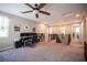 Bright loft space featuring a ceiling fan, built-in shelves, and a functional desk area for work or study at 3698 Regatta Landing Dr, Las Vegas, NV 89141
