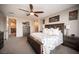 Comfortable main bedroom features a ceiling fan, dresser, nightstands, and entry into the main bathroom at 3698 Regatta Landing Dr, Las Vegas, NV 89141