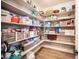 Walk-in pantry with built-in shelves and wood-look flooring, perfect for organization and storage at 3698 Regatta Landing Dr, Las Vegas, NV 89141