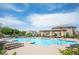 Inviting community pool area with ample lounge seating, lush landscaping, and a pergola at 3698 Regatta Landing Dr, Las Vegas, NV 89141