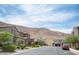 Scenic neighborhood street view with well-maintained homes and beautiful landscaping against a mountain backdrop at 3698 Regatta Landing Dr, Las Vegas, NV 89141