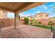 A covered patio extends to a green space bordered by brick, offering a cozy outdoor living area at 3746 Asia Rd, North Las Vegas, NV 89032