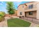 Charming backyard featuring artificial turf, desert landscaping, and a patio at 3746 Asia Rd, North Las Vegas, NV 89032