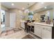 Well-lit bathroom featuring double sinks, vanity area, ample counter space, and modern fixtures and tile floors at 3746 Asia Rd, North Las Vegas, NV 89032