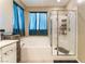Bright bathroom featuring a tub, glass-enclosed shower, and double windows at 3746 Asia Rd, North Las Vegas, NV 89032