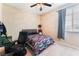 Cozy bedroom with a ceiling fan and natural light from the window at 3746 Asia Rd, North Las Vegas, NV 89032