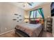 Bedroom with comfortable bed, decorative shelves, and ample natural light from the window at 3746 Asia Rd, North Las Vegas, NV 89032