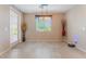 A modern dining room features large windows and neutral décor, complete with tile flooring at 3746 Asia Rd, North Las Vegas, NV 89032